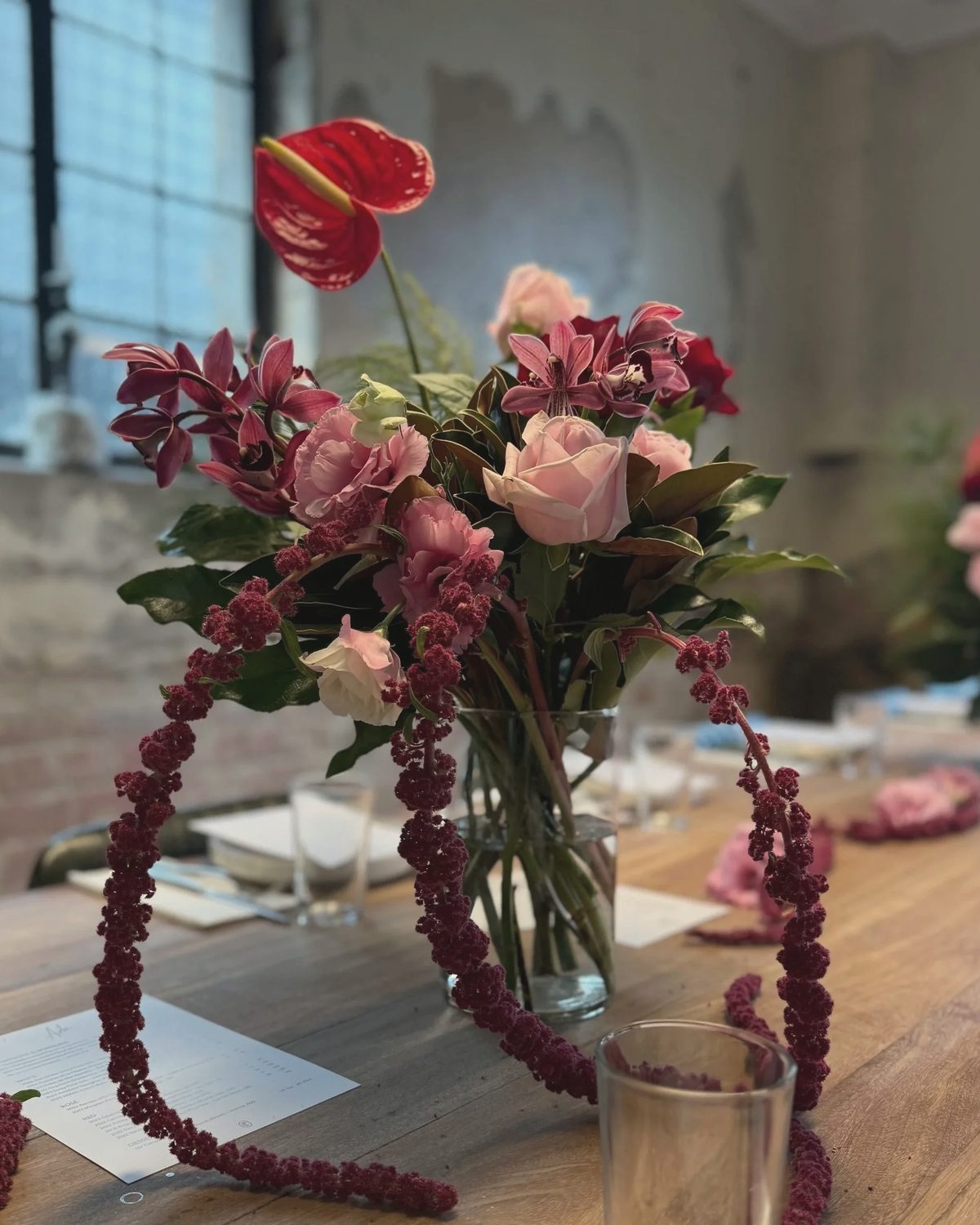 Pink and burgundy flowers on a timber table