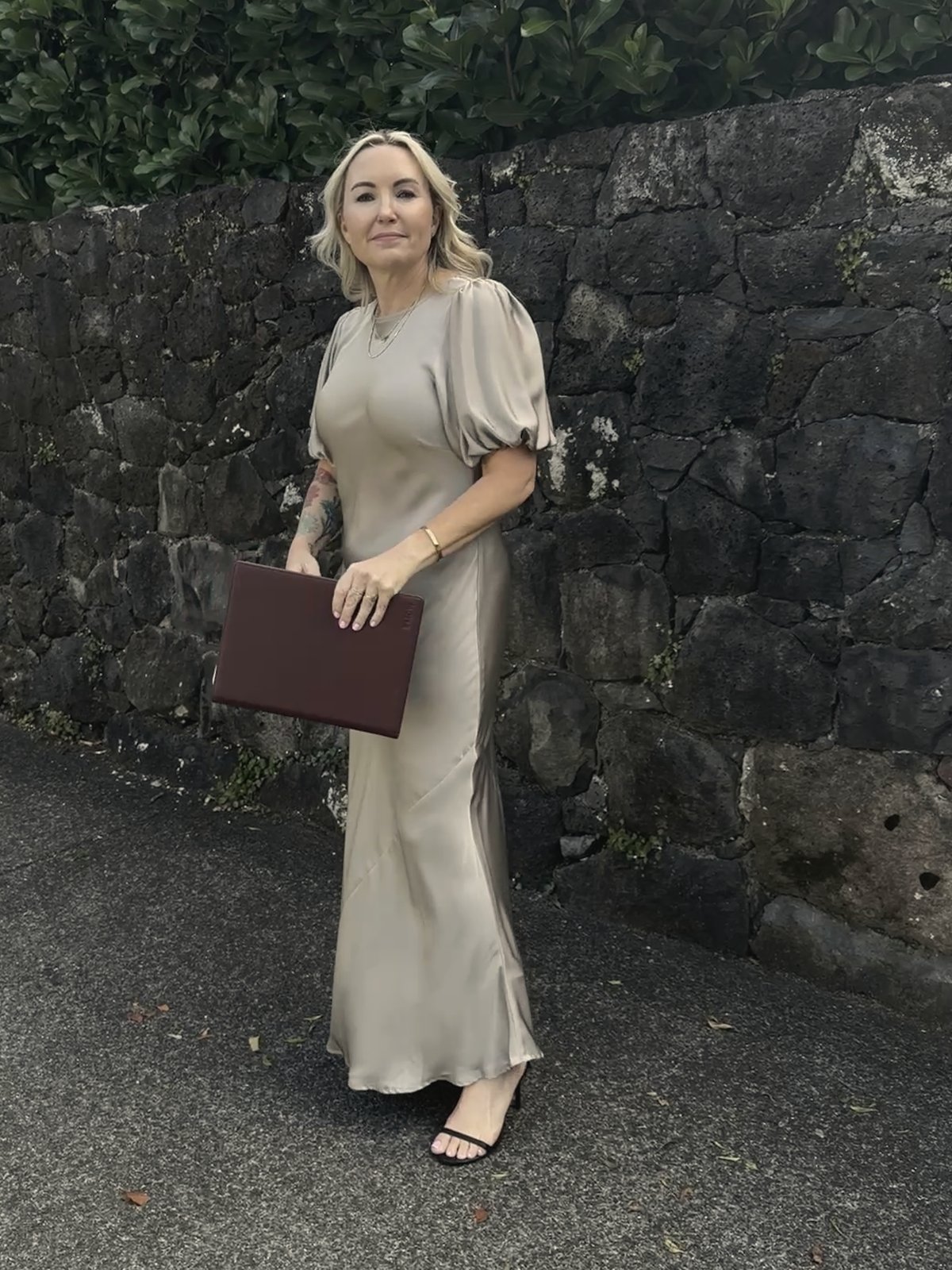 Lizzi holding her burgundy ceremony folder