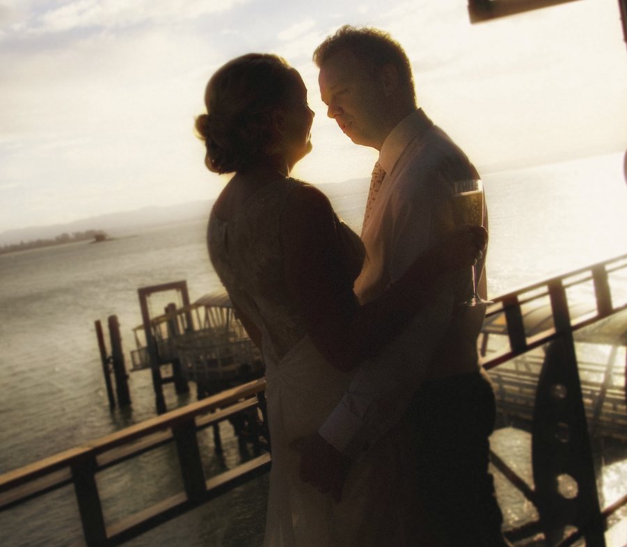 Silhouette of a couple at sunset by the water