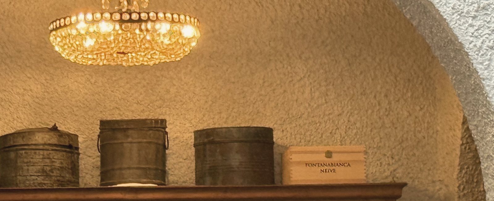 A warm arched venue with a chandelier